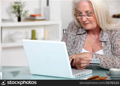 A mature lady doing online shopping.