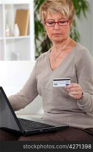 A mature woman doing online shopping.