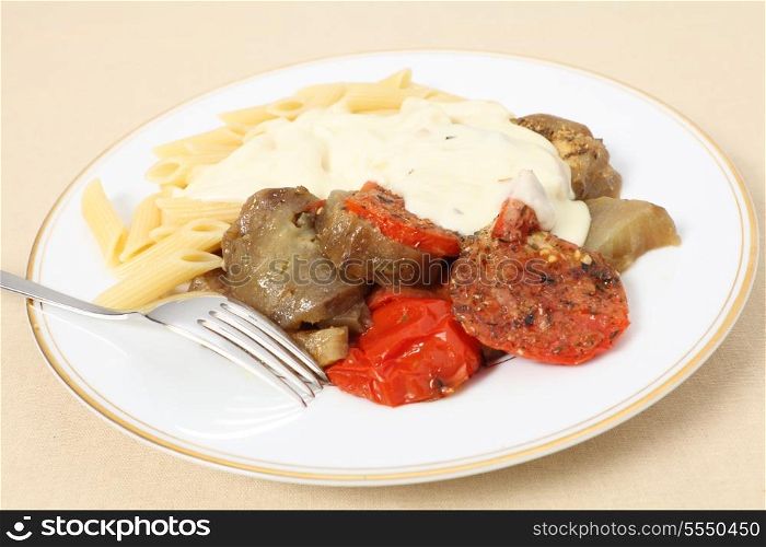 A meal of baked tomato and eggplant (aubergine) served with penne pasta and topped with a cheese sauce. Full recipe at my blog http://wp.me/p1WA0Y-h