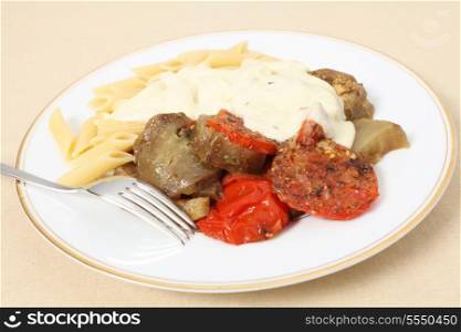 A meal of baked tomato and eggplant (aubergine) served with penne pasta and topped with a cheese sauce. Full recipe at my blog http://wp.me/p1WA0Y-h