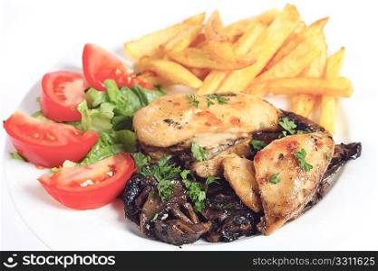 A meal of chicken fried chicken breasts on a bed of sauteed mushrooms, served with french fried potato chips and a salad of tomato and lettuce