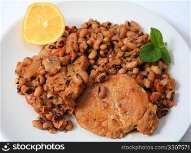 A meal of pork cooked with black-eyed beans, tomato, celery, onions and olive oil, a traditional Greek recipe