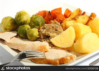 A meal of roast turkey with all the trimmings - brussels sprouts, roast sweet potatoes, roast parsnips stuffing and boiled potatoes