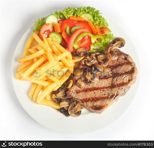 A meal of steak with mushrooms, french-fried potatoes and salad viewed from above.
