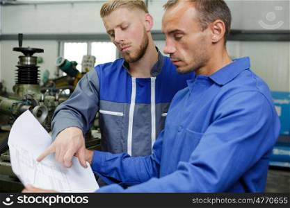 a mechanic man holding papers