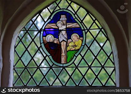 A mediaeval stained glass church window depicting the Crucifixion