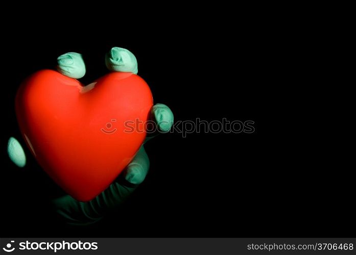 A medical professional holding a red heart.