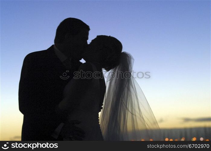 A Melbourne Wedding. Couple kissing at sunset. silhouette of lovers. 2003