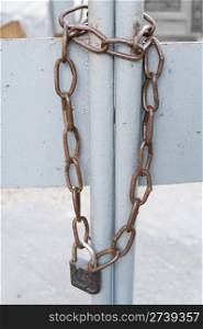 a metal chain with a padlock on a gate