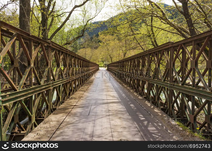 A metallic bridge across a mountain river.. A metallic bridge across a mountain river at Evrytania, Greece