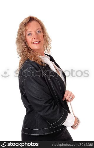A middle age business woman in a black skirt and navy jacket standingin profile, isolated for white background.
