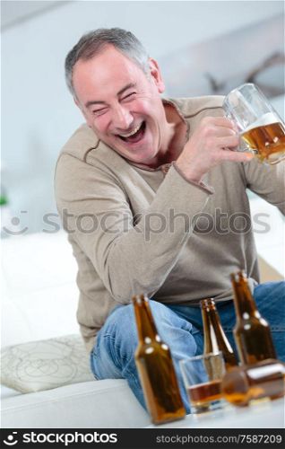 a middle age man drinking beer