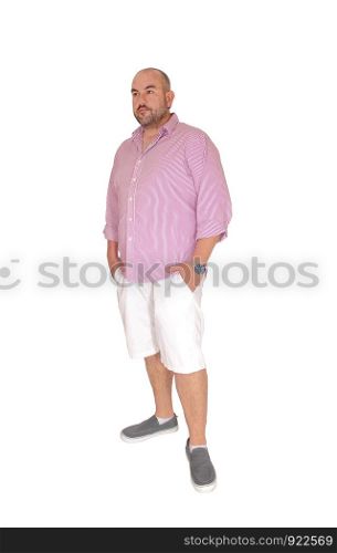 A middle age man in white shorts and striped shirt standing with his hands in his pocket looking at the camera, isolated for white background