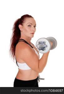 A middle age woman standing in profile lifting her dumbbells whit her long red hair and workout outfit, isolated for white background
