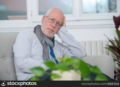 a middle-aged man relaxing a moment in sofa