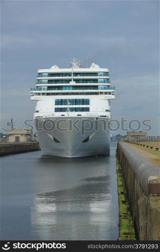 A middle sized cruise ship waiting in a dock