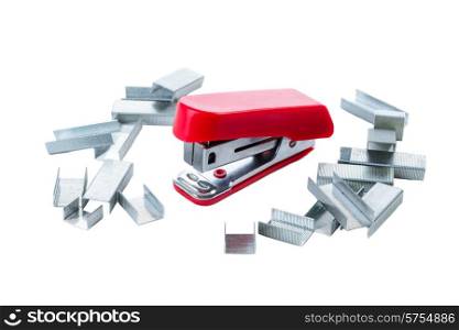 A mini red stapler on a white background and surrounded by the small staples used in this size stapler.