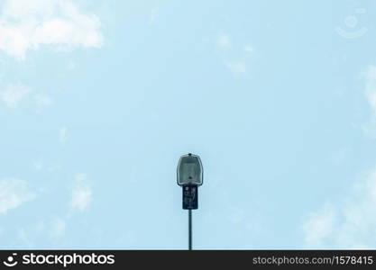 A minimalistic shot of a single street lamp with the sky as the background