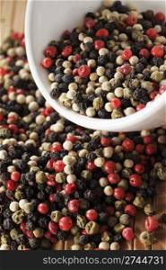 A mix of black, green, red and white peppercorns.