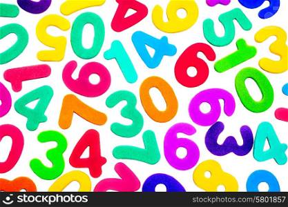 A mix of different single digit numbers from zero to nine, of different bright colours, on a white background.