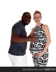 A mixed couple, black man Caucasian woman pregnant standing forwhite background with thumps up and very happy.
