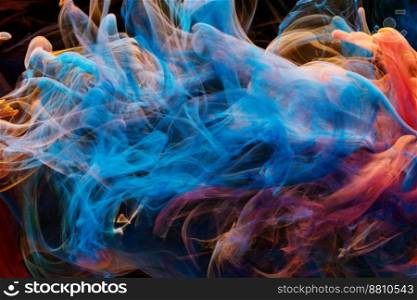 A mixture of colorful ink swirls in water on a black background. Abstract concept photo.