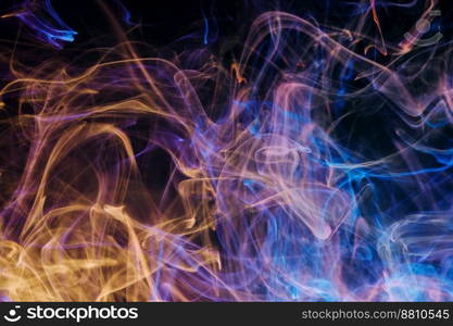 A mixture of colorful ink swirls in water on a black background. Abstract concept photo.