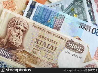 A mixture of old Greek drachma banknotes and euro notes that succeeded them. Greece&acute;s adoption of the single currency, despite its budget difficulties, is now seen as posing a threat to the entire euro currency project, undermining the euro exchange rate.