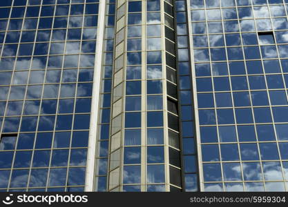 a modern apartment building with clouds reflection