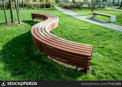 A modern bench in a city park on a sunny day