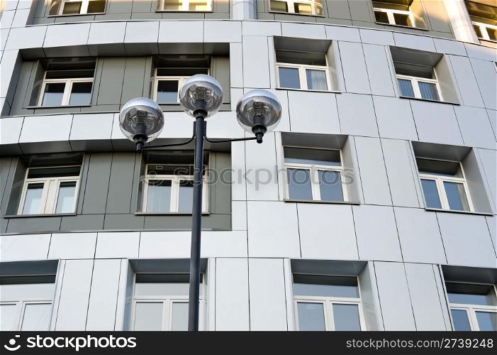 a modern street lamp against a modern building