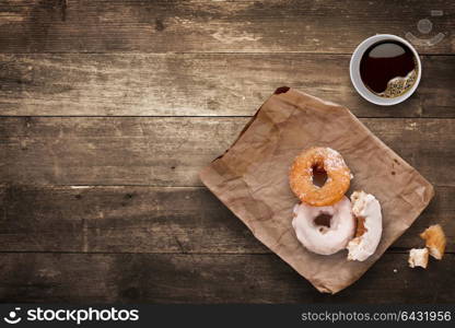 A morning lunch in the office consisted of a cup of black takeaway coffee and tasty donuts.