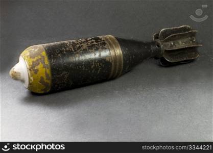 a mortar bomb black and yellow very old and rusty