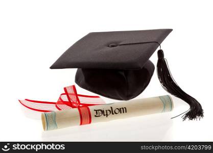 a mortarboard and a diploma lying on a white background