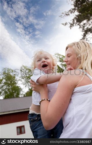 A mother and son spending time together outdoors in a rural setting