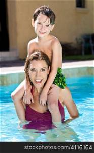 A mother having fun with her son on her shoulders in a swimming pool