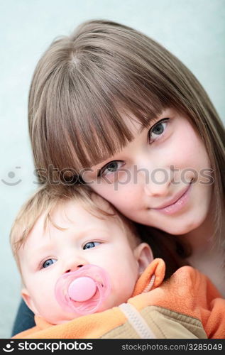 A mother holding her little baby girl