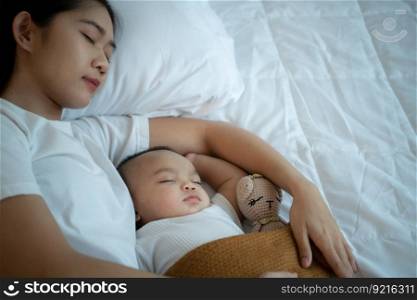 A mother must sleep and rest with her newborn baby. In the white bedroom, warm sunlight in the evening of the day. to be ready to wake up and continue to take care of the baby&rsquo;s life
