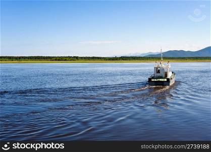 a motor boat sailes towards a shore