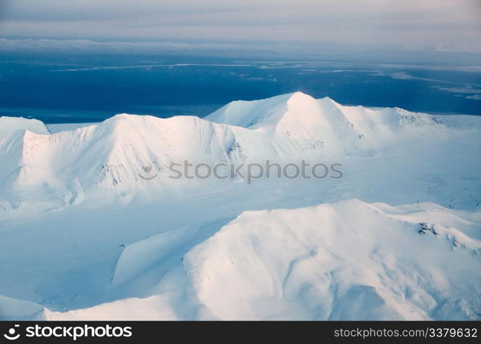 A mountain landscape filled with snow, Svalbard, Norway
