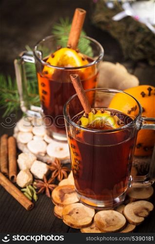 A mulled wine in the glass cup on wooden background