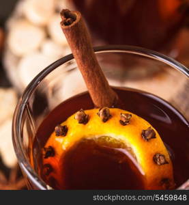A mulled wine in the glass cup on wooden background