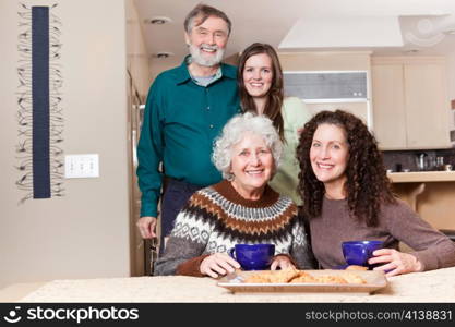 A multi generation portrait of happy grandparents with their daughter and granddaughter spending time together