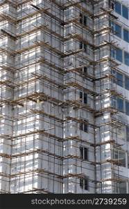 a multistorey panel building under construction, in scaffolding