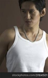 A muscular asian male model in a white vest