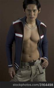 A muscular asian male model shows his torso