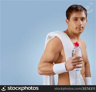 a muscular handsome man with bottle of water