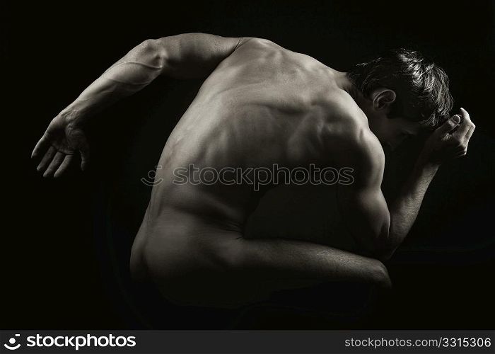a muscular man posing artistic