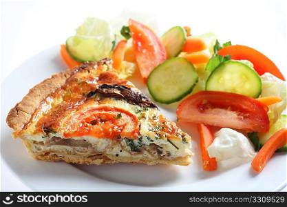 A mushroom, tomato and parsley quiche served with a salad.