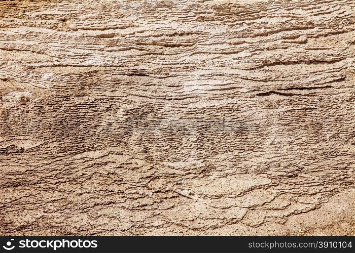 A natural texture background of hundreds of layers of calcium carbonate formed over years from one of the mineral springs at Mammoth Hot Springs in Yellowstone National Park.